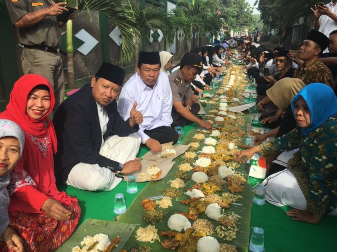 
Warga Grati Gelar Tasyakuran Makan Bareng di Atas Daun Pisang Sepanjang 500 Meter
